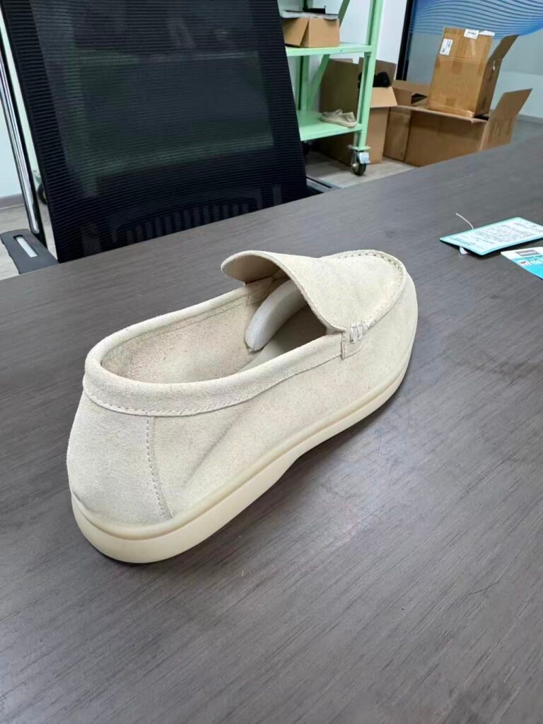 beige cow suede loafer prototype undergoing sample development review